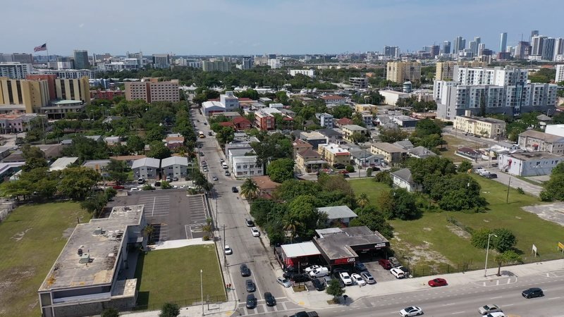 Wide aerial view of the neighborhood around the property